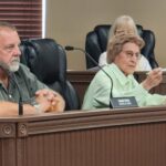 Duane Tatar looks on as Edie Viola offers remarks during her final meeting after 28 years on Westover City Council.